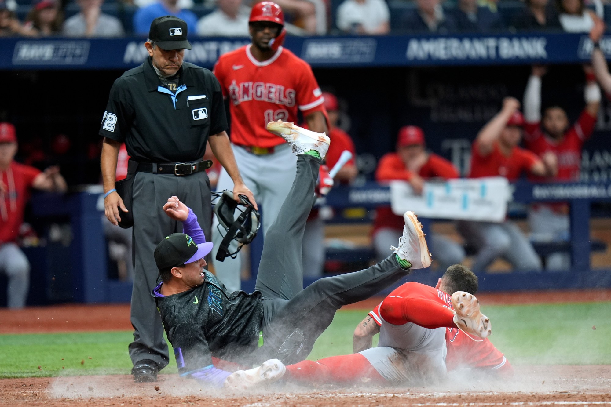 Tampa Bay Rays pitcher Ian Seymour, left, falls over the Angels’ Zach Neto after Neto scored on a wild pitch during the seventh inning Saturday, May 30, 2026, in St. Petersburg, Fla. (AP Photo/Chris O’Meara)
